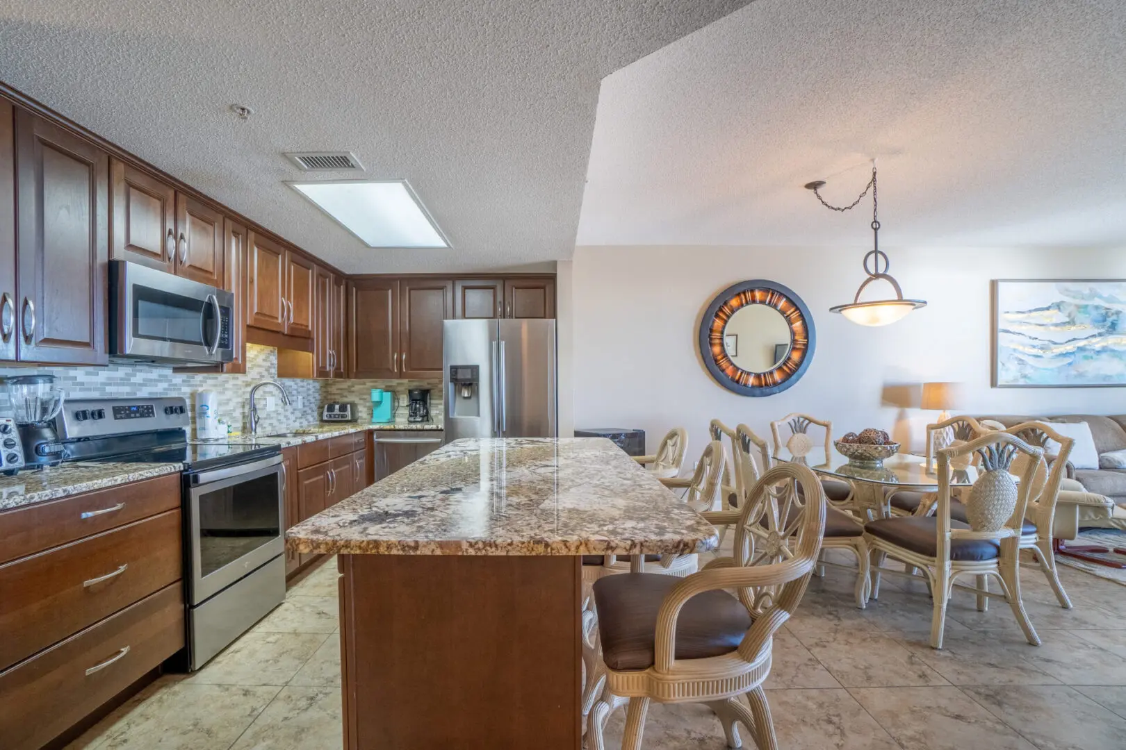 A kitchen with a dining table and chairs.