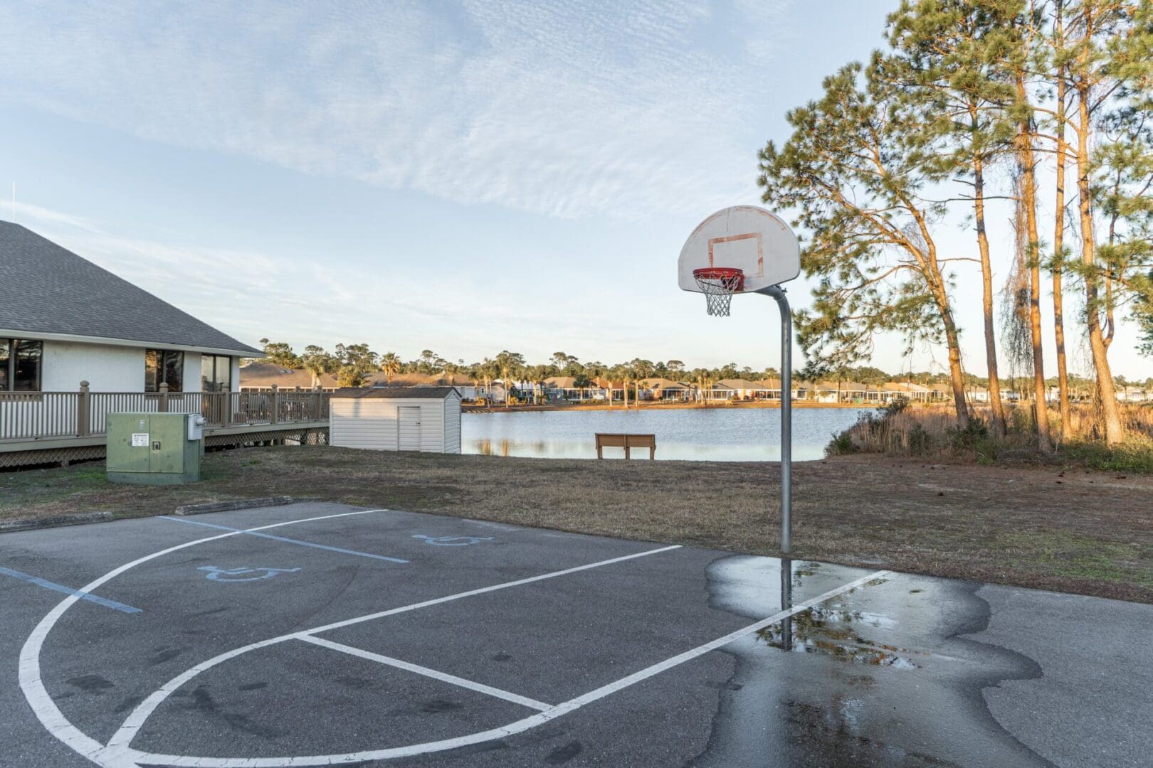 A basketball court with water on the ground.