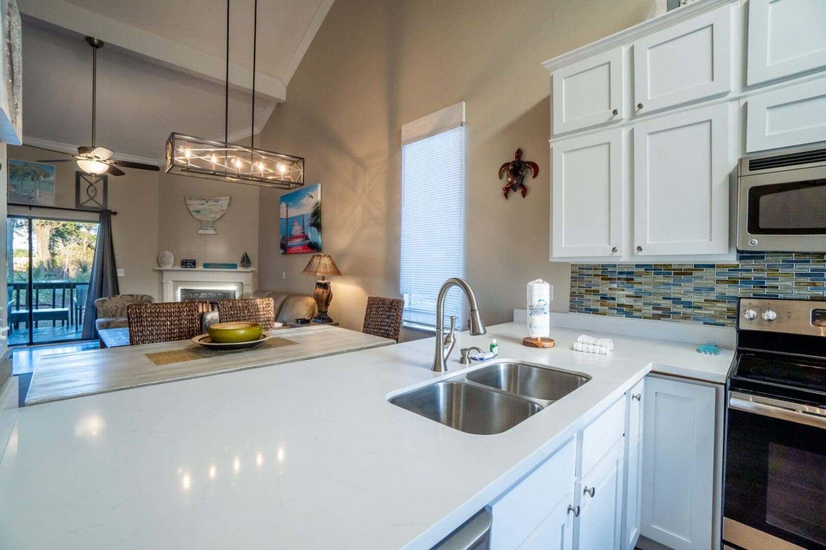 A kitchen with white cabinets and a sink.