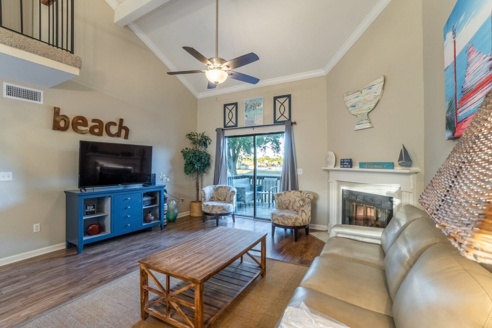 A living room with a couch, chair and television.