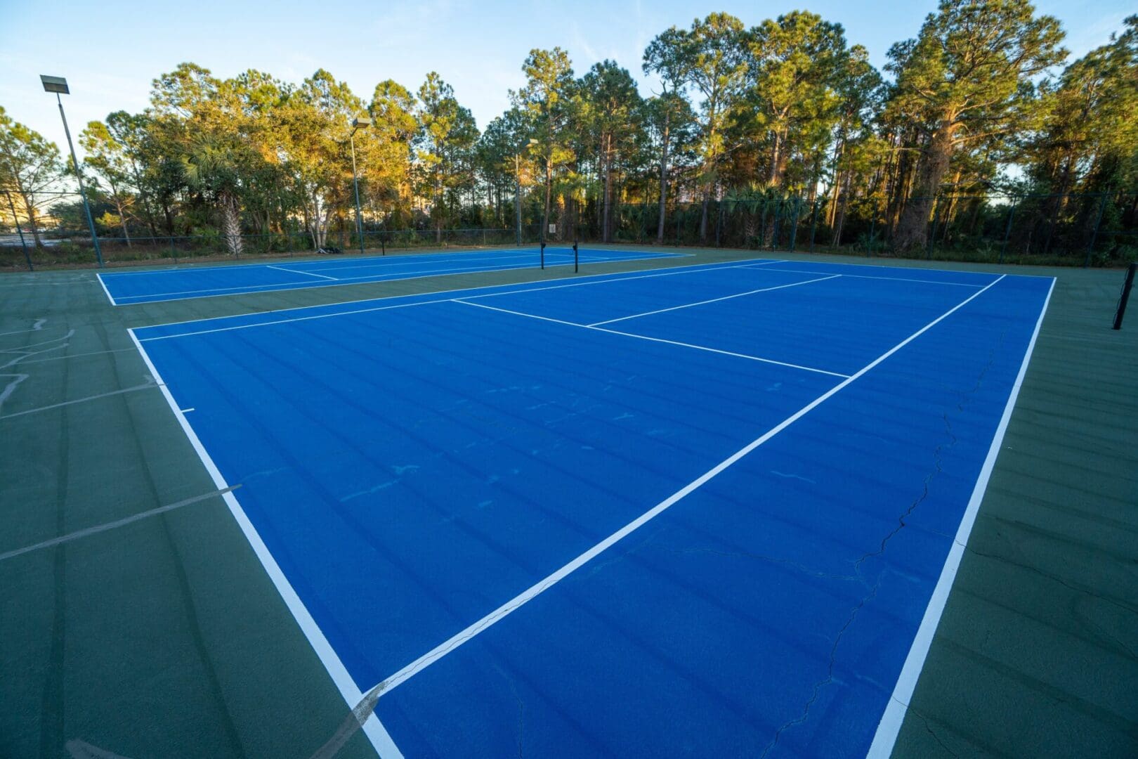 A tennis court with trees in the background.