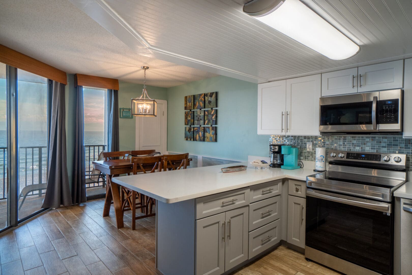 A kitchen with a dining room table and chairs.