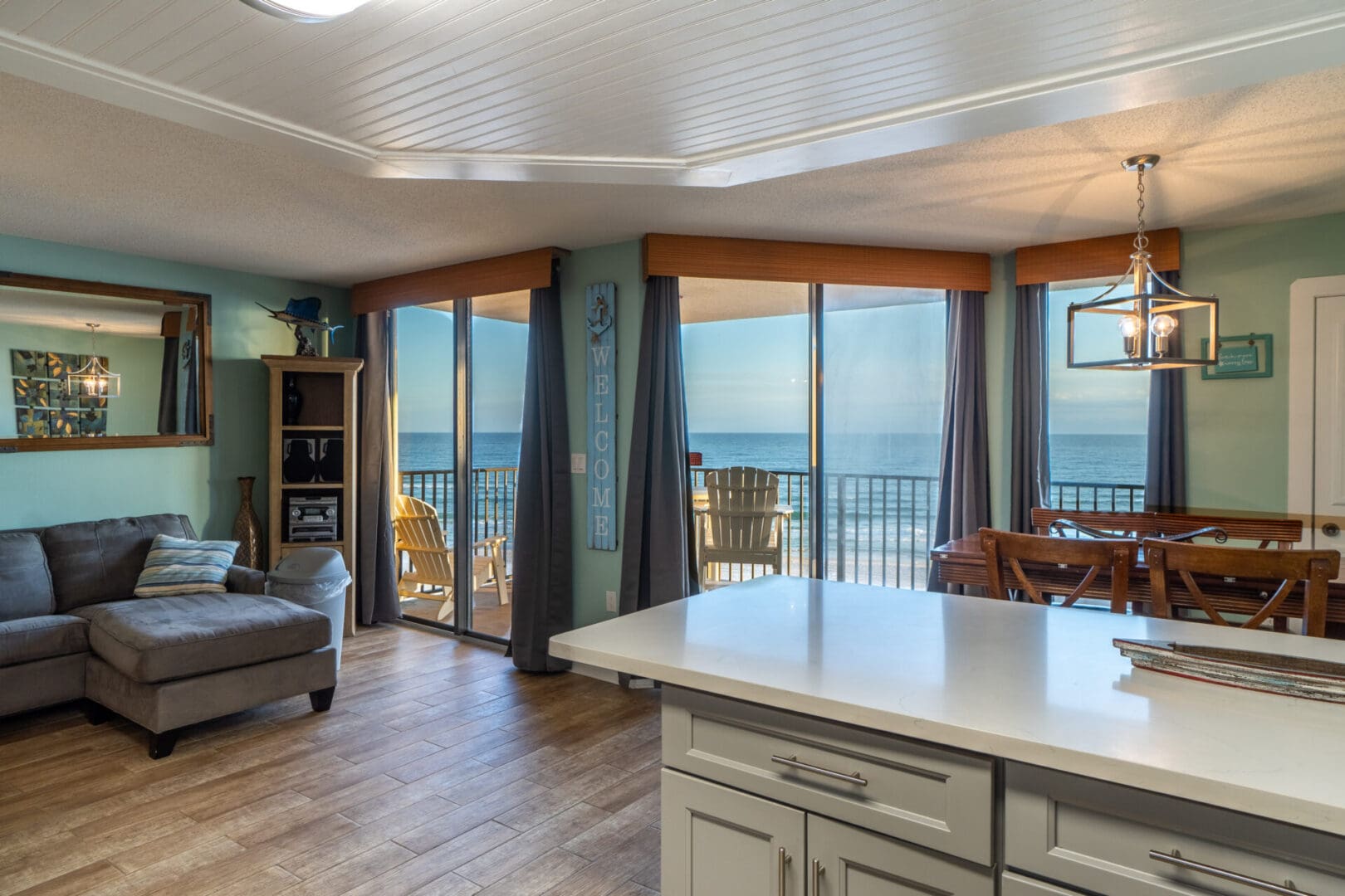 A kitchen with a large window and a view of the ocean.