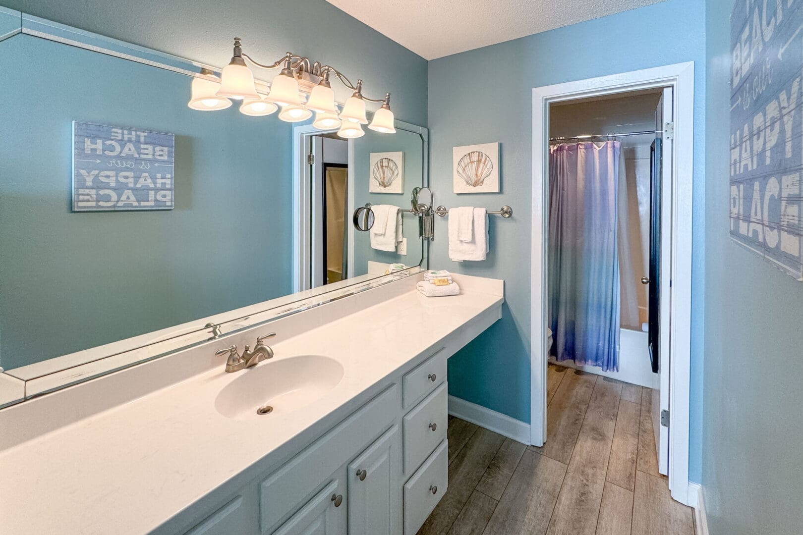 A bathroom with two sinks and a large mirror.