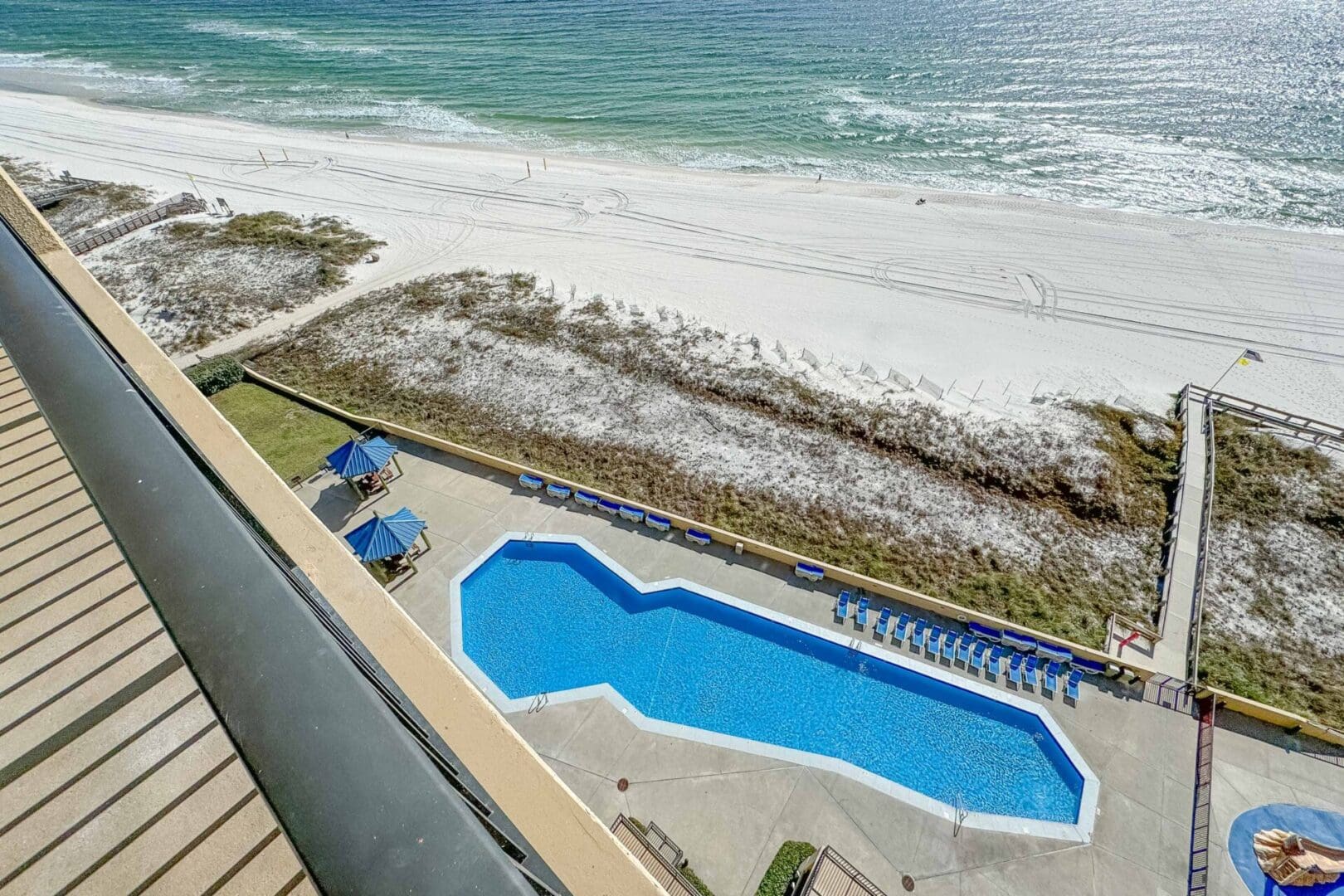 A view of the ocean from above shows an empty pool.