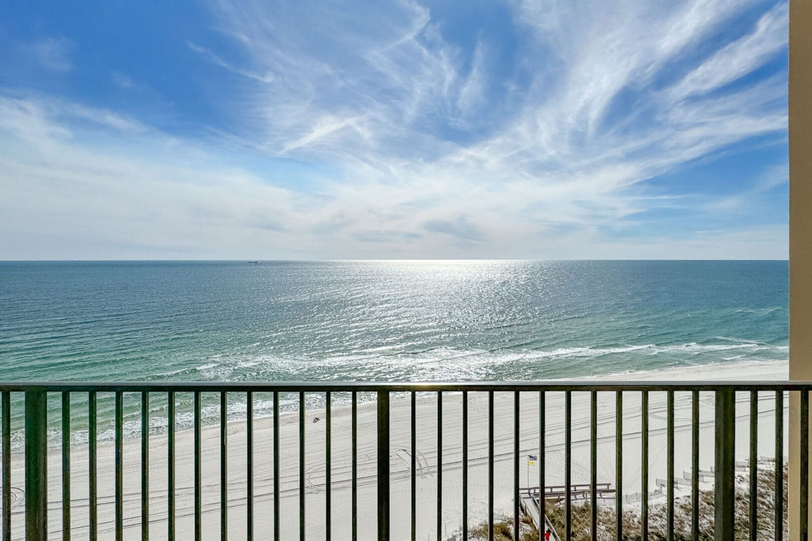 A view of the ocean from an apartment balcony.