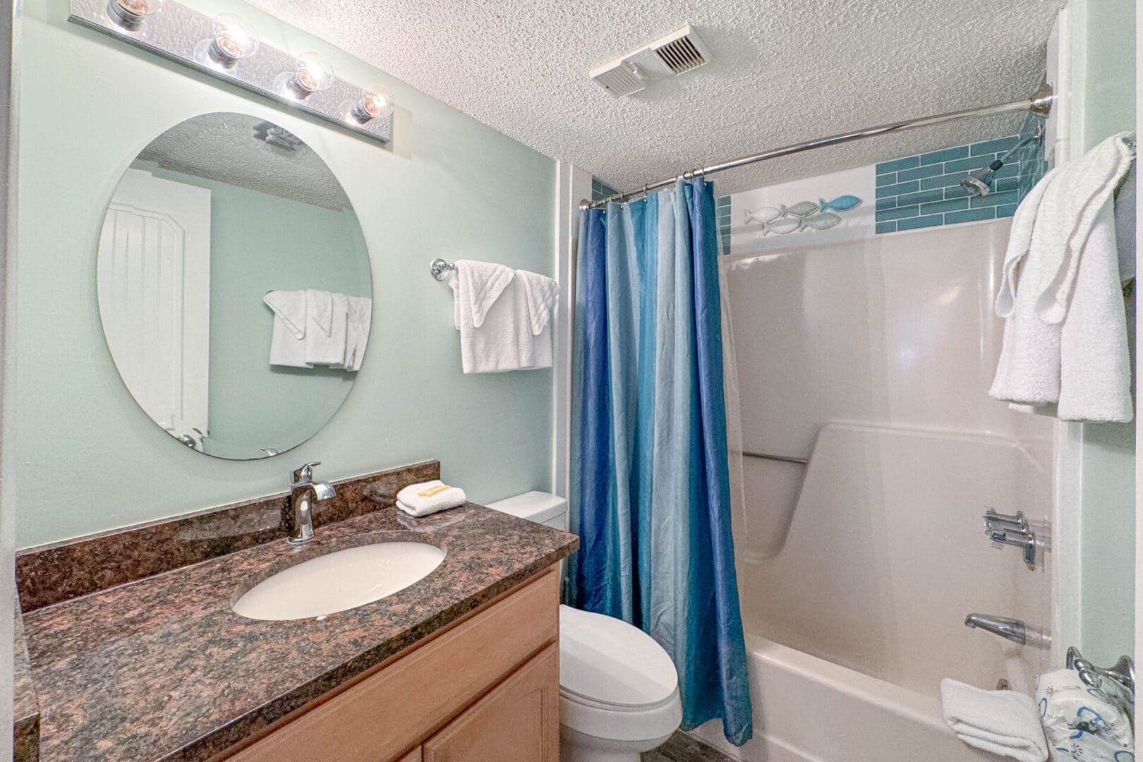 A bathroom with a sink, toilet and bathtub.