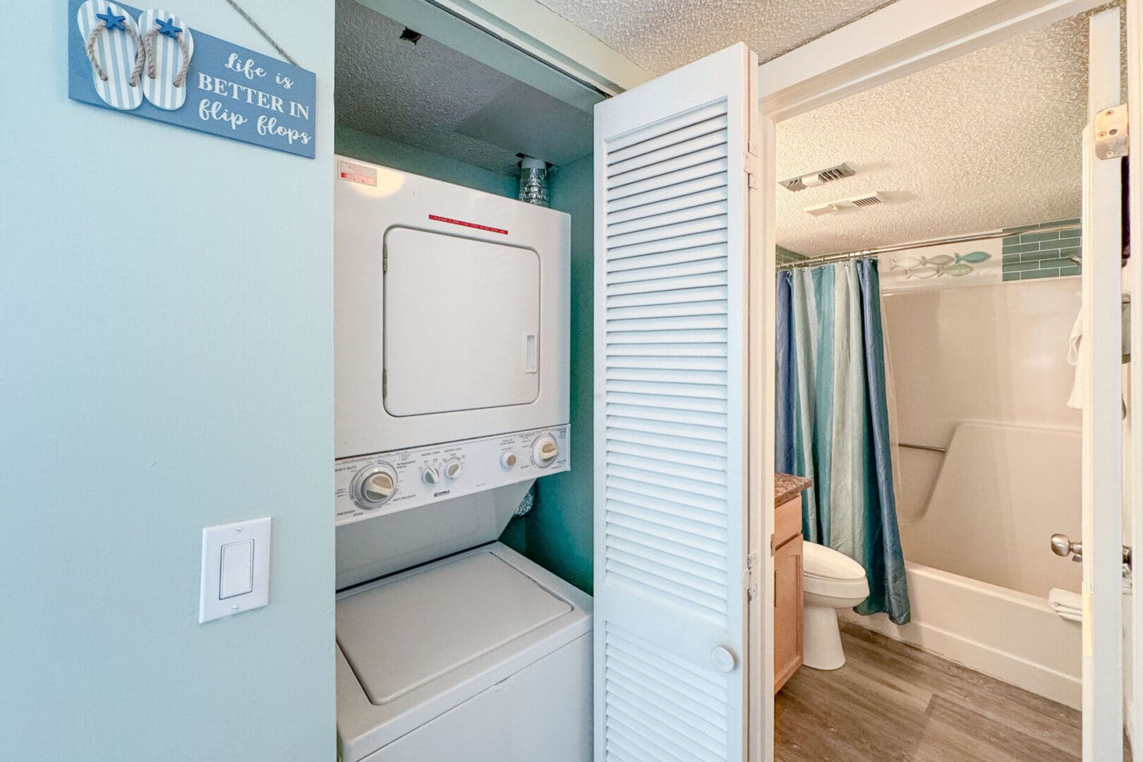 A bathroom with a washer and dryer in it