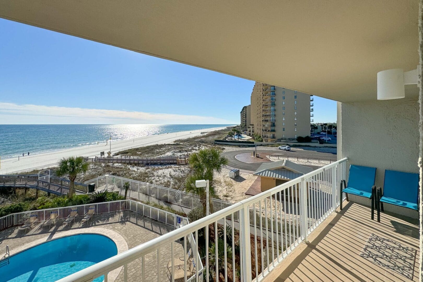 A balcony with a view of the ocean and beach.