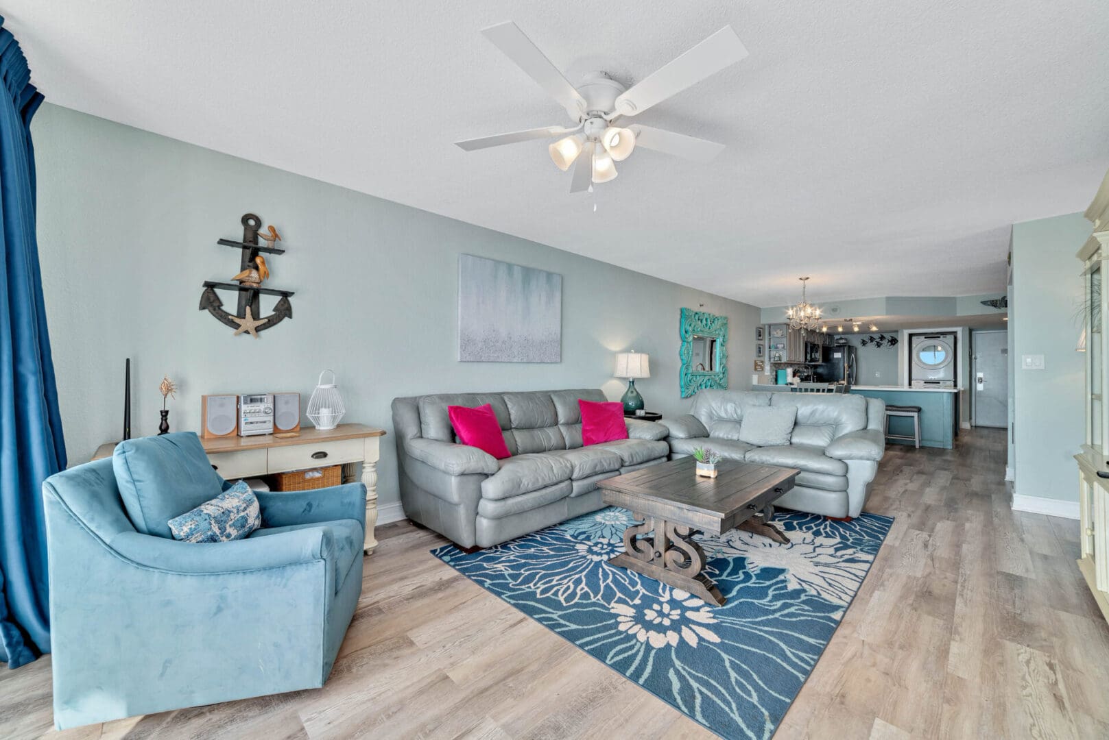 A living room with couches, chairs and a table.