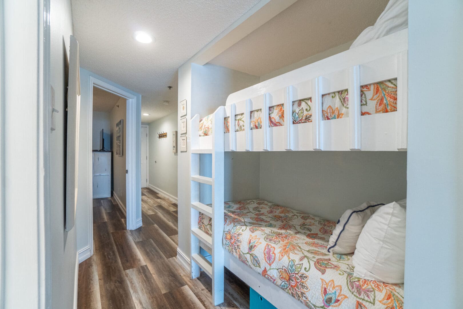 A room with two bunk beds and a wooden floor