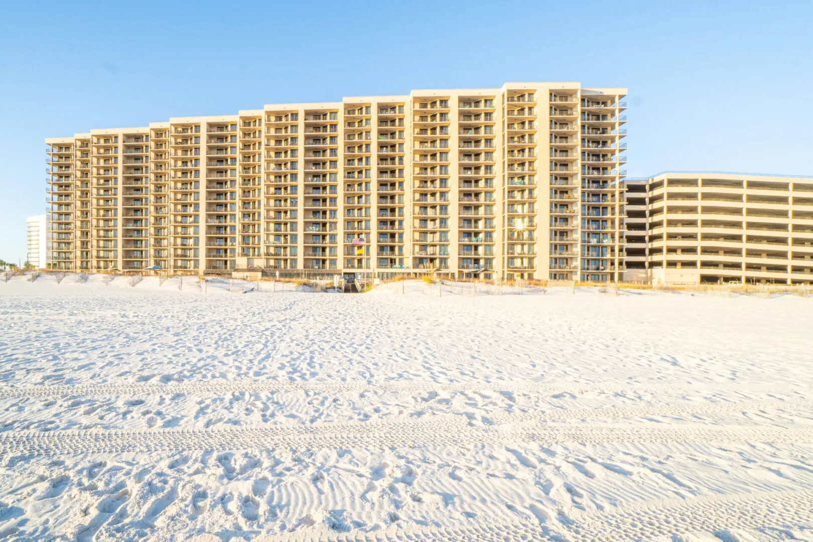 A beach with many tall buildings in the background.