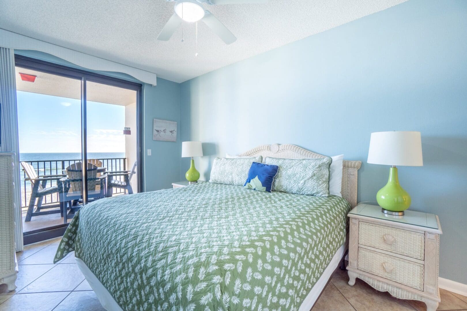 A bedroom with a bed, nightstand and window.