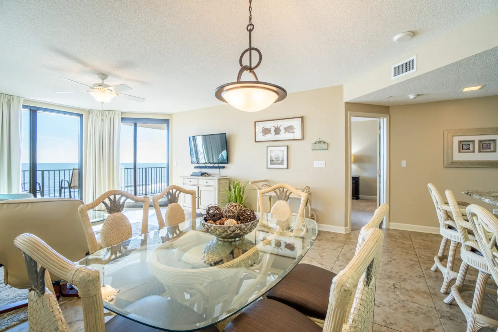 A dining room table with chairs and a television.