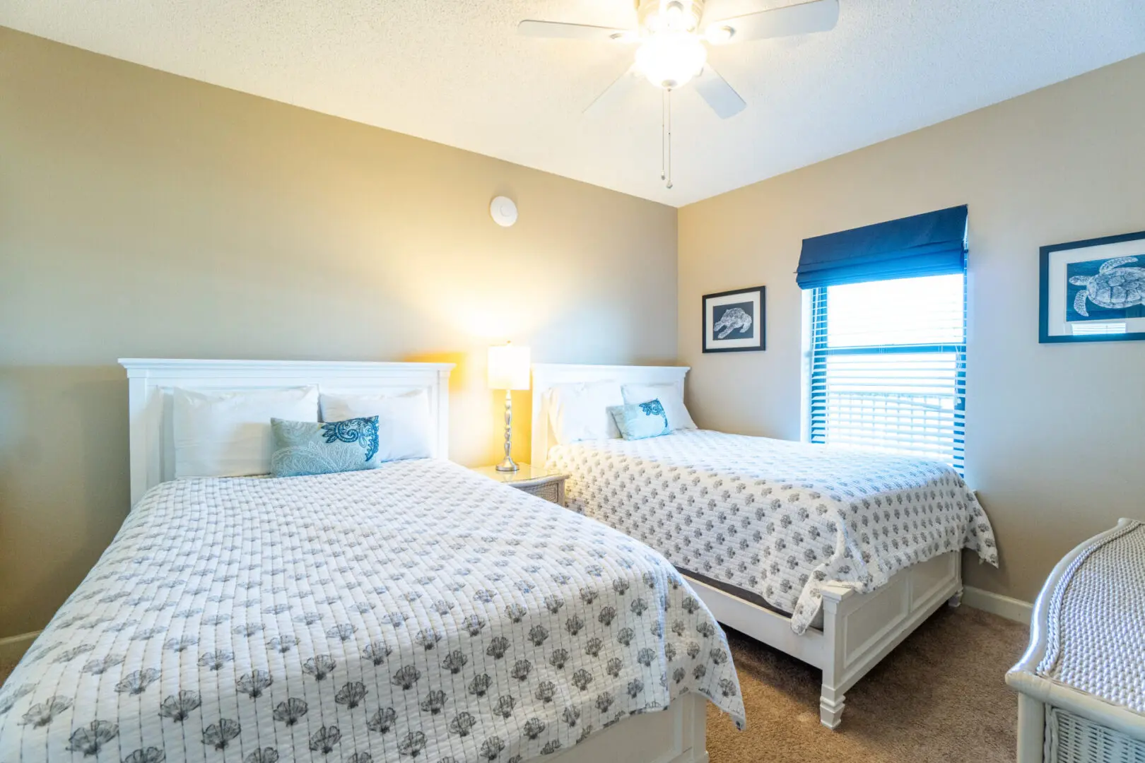 A bedroom with two beds and a window.