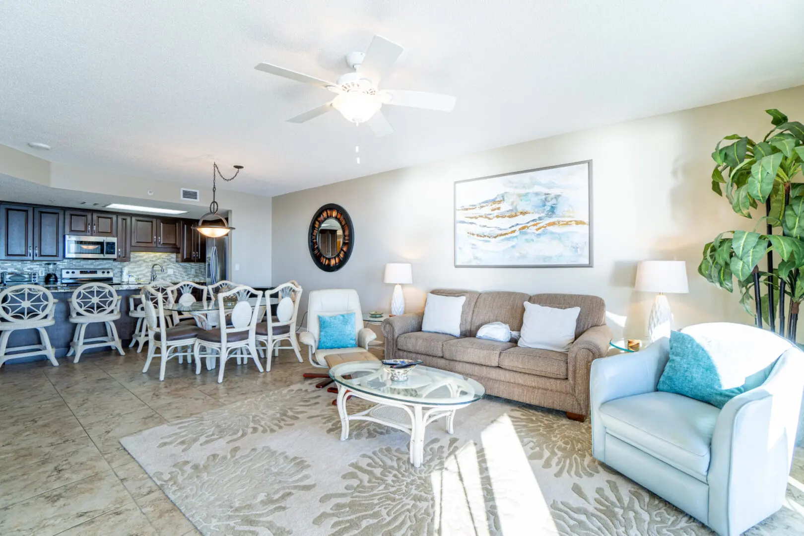 A living room with a couch, chairs and table.