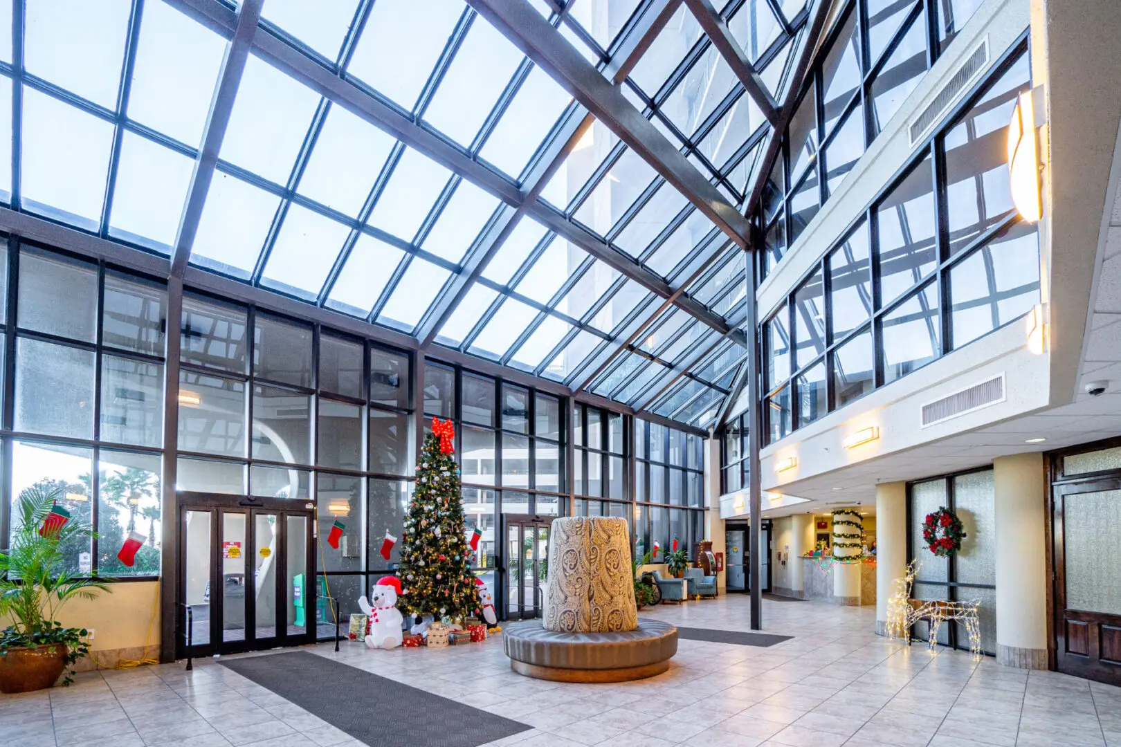 A large lobby with a christmas tree and decorations.