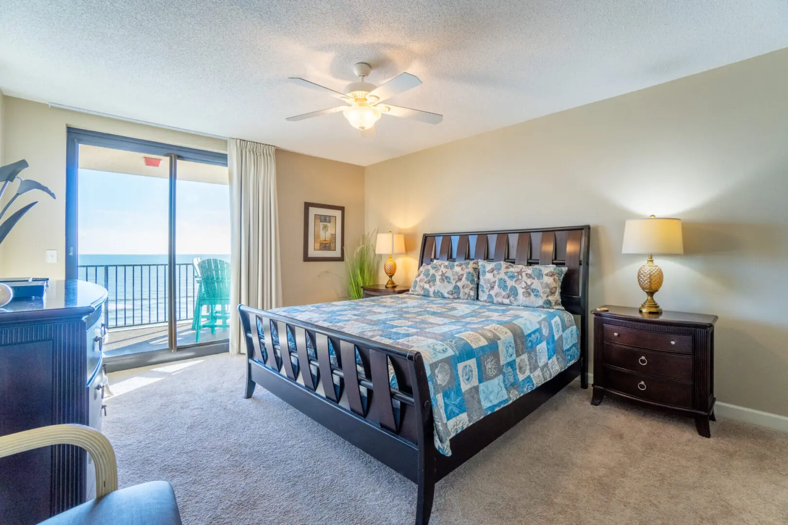 A bedroom with a bed, nightstand and window.